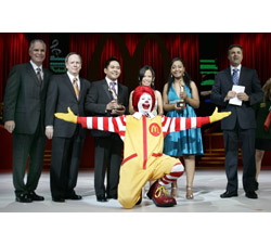 “Voice of McDonald’s® II” finalists celebrate their titles following the final global singing competition in Orlando, Fla., on April 17.  From left: Ralph Alvarez, McDonald's Chief Operating Officer; Jim Skinner, McDonald's Chief Executive Officer; third place winner Candido Revilles; Ronald McDonald; second place winner Mary Margaret Yu; first place winner Nat�rcia Pintor; and competition host Mark Wahlberg.